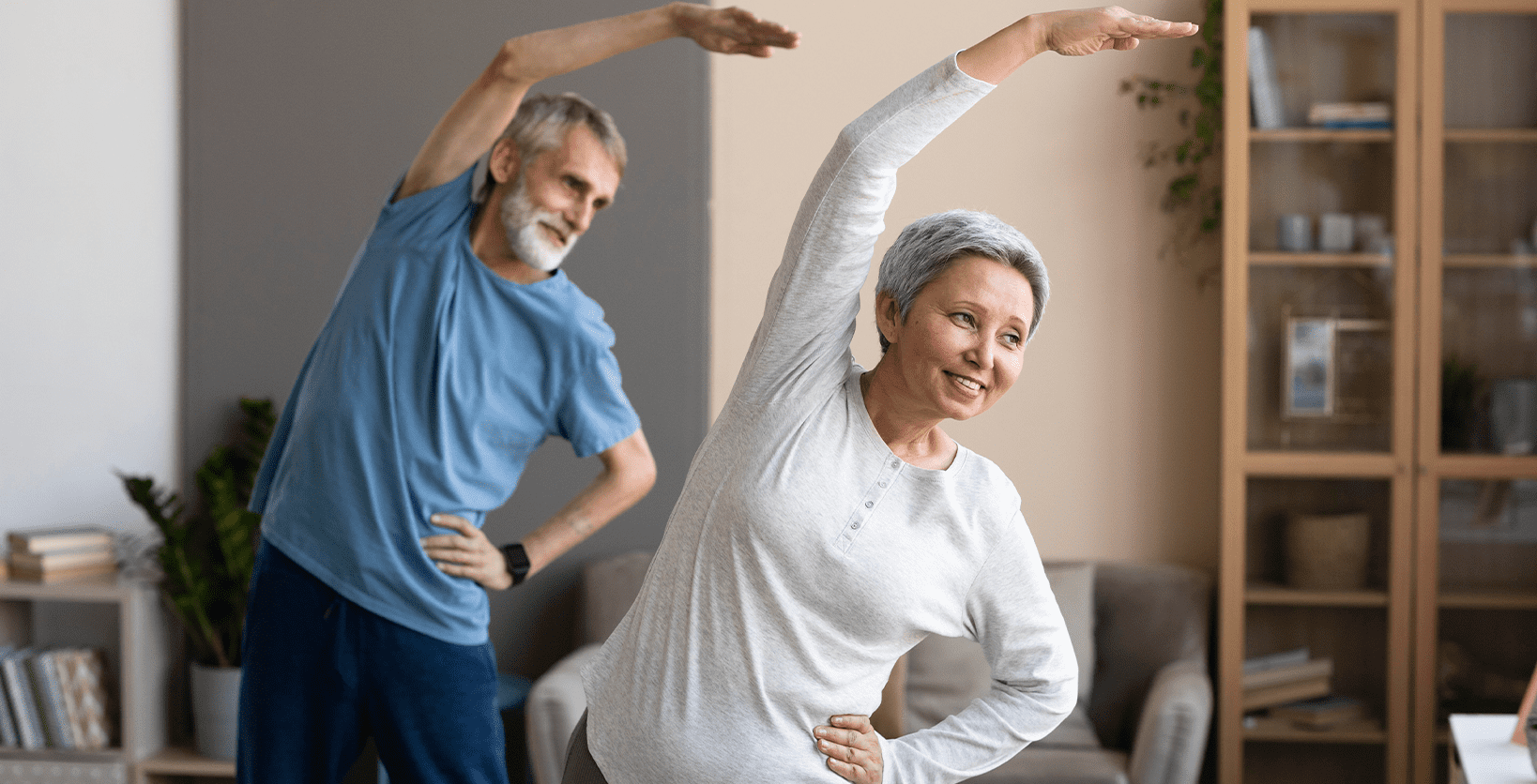 An older couple stretches for exercise.