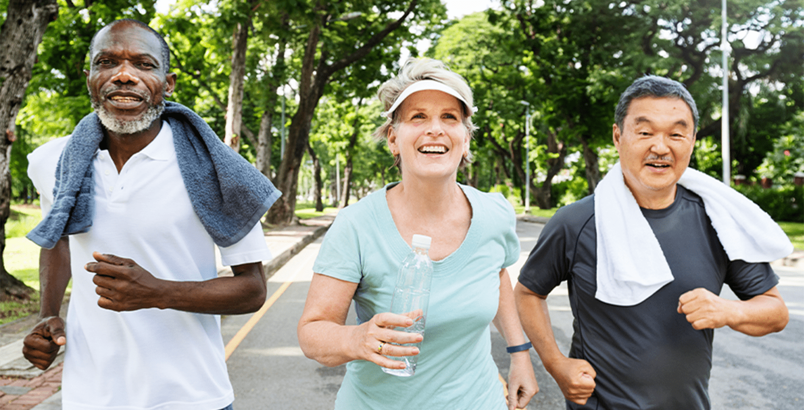 Two men and a woman run along a residential street to exercise