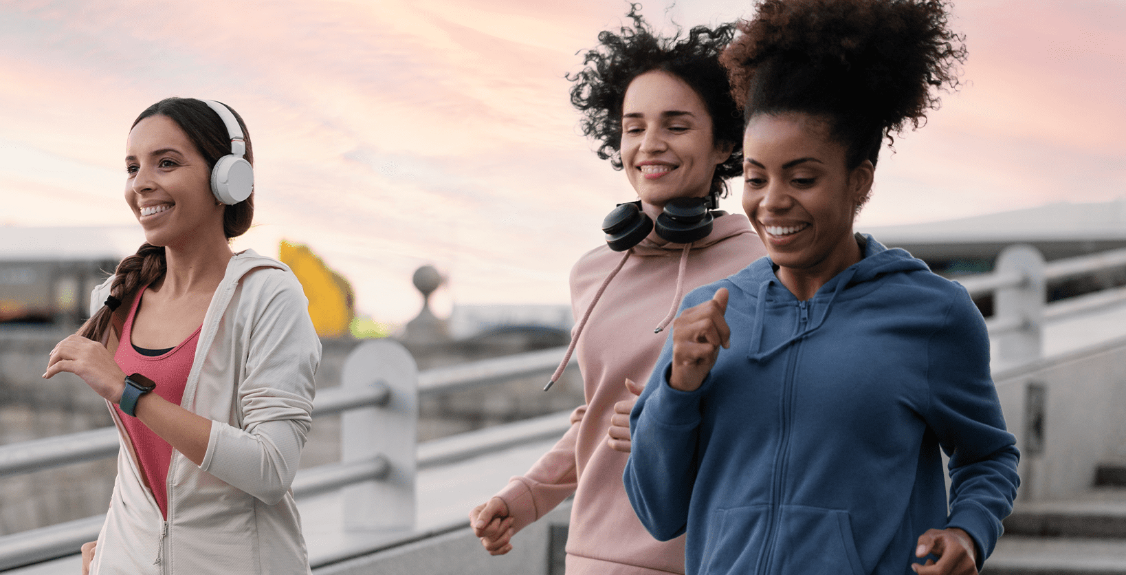 A trio of young women jog for exercise.